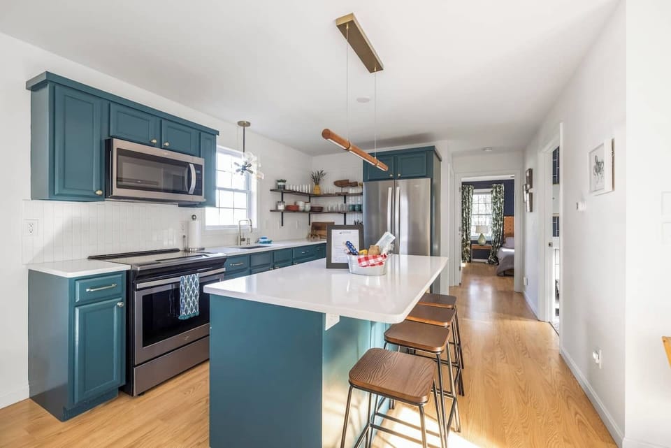 Bright, modern kitchen with spacious island seating and a clean, coastal-inspired design.