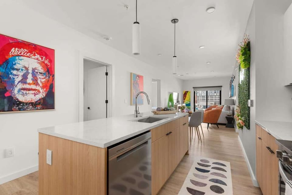 Long spacious kitcheChef's  kitchen fully equipped and stocked with essentialsn open to the living area and fully equipped and stocked with coffee, tea, sugar, salt, pepper, olive oil, balsamic vinegar, pots and pans, dishes, Keurig coffee maker, 4-b