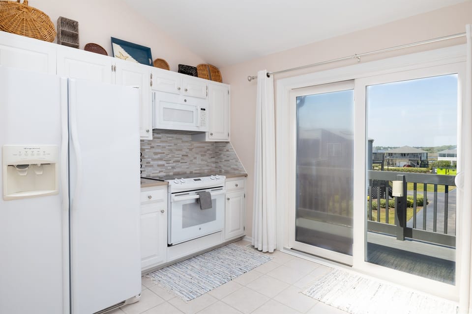 Large, clean kitchen with balcony
