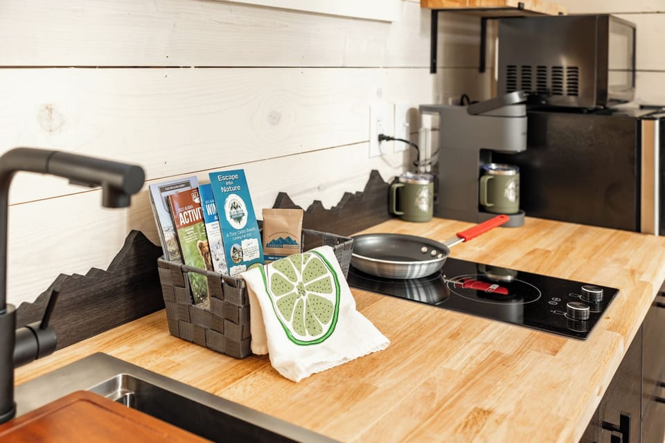 Tiny cabin kitchenette has a stove and coffee service includes a starter pack of coffee for the pot.