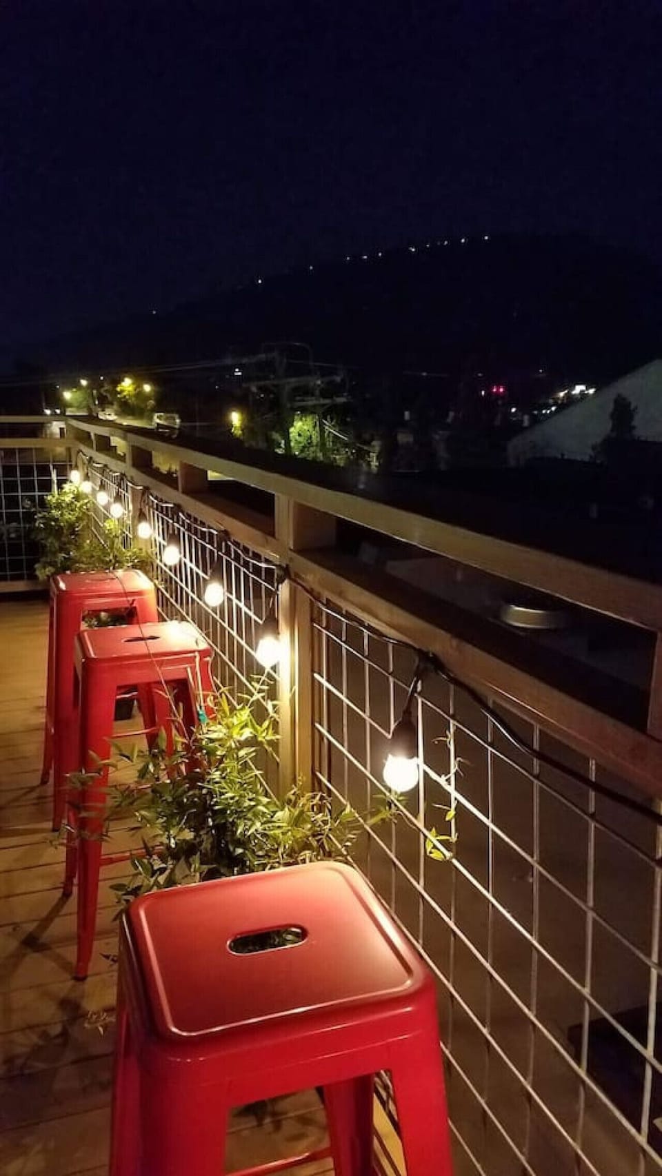 Private rooftop deck—sunset views, string lights, and celebration-ready.