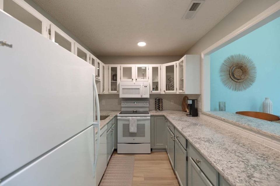 Cook like a local in this modern, fully equipped kitchen featuring a gas stove, stainless steel appliances, and all the essentials for dining in.