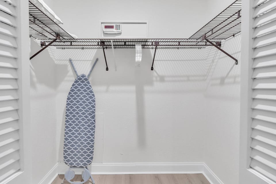 Walk in closet with ironing board & iron!