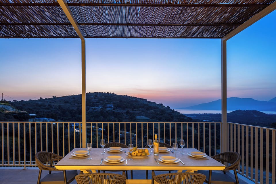 An outdoor dining table for 8 guests under a shaded pergola