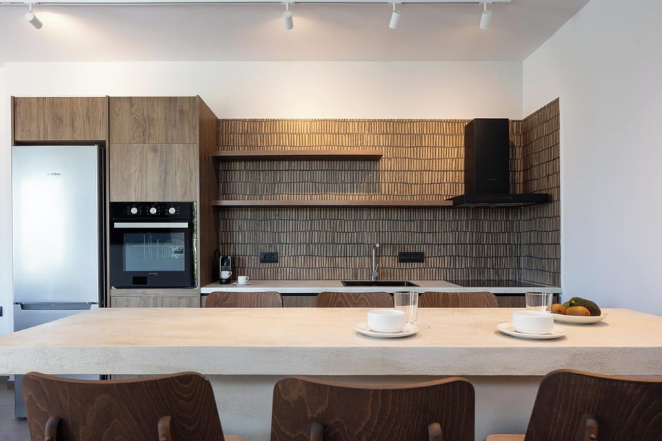 A fully equipped kitchen with modern appliances accompanied with a 6 seater dining table