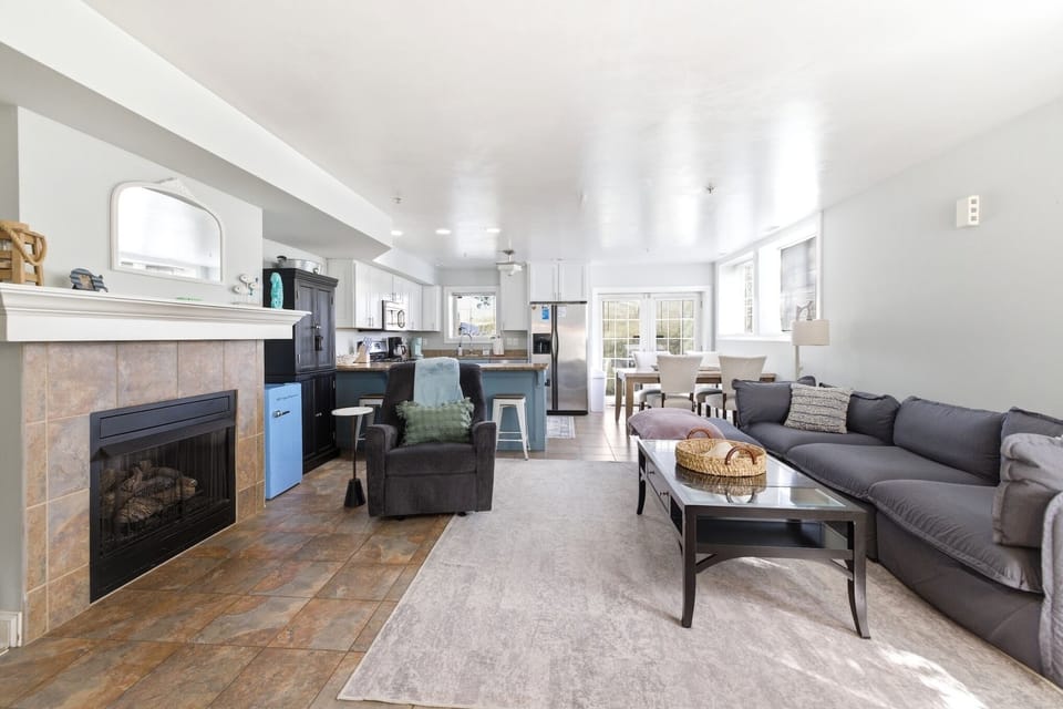 Gather together in the spacious living room with fireplace warmth and cozy seating