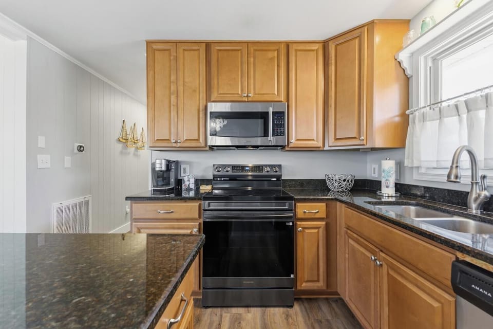 Your fully equipped kitchen features modern appliances, ample counter space, and warm wood cabinetry—perfect for preparing meals during your stay.