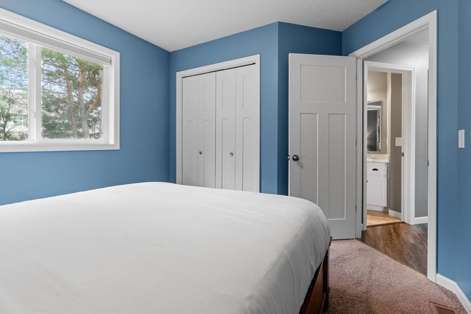 Drift off to sleep in your serene blue bedroom, where natural light streams through the window and soft carpet cushions your steps.