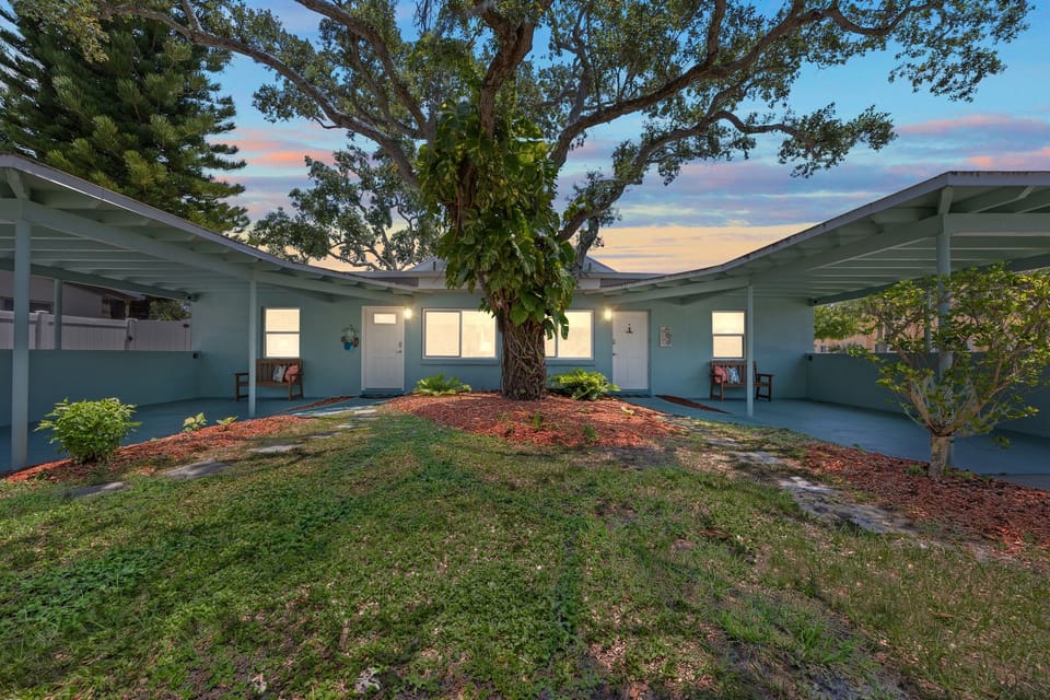 Outdoor Oasis: Relax under the shade of a majestic tree in this tranquil courtyard retreat!