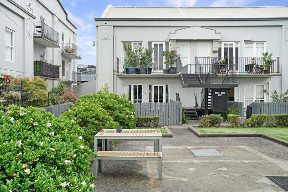 There is a private courtyard with a seating area in addition to this shared green sitting area.