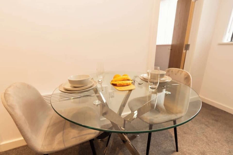 Dining table with kitchenware as unit amenities.