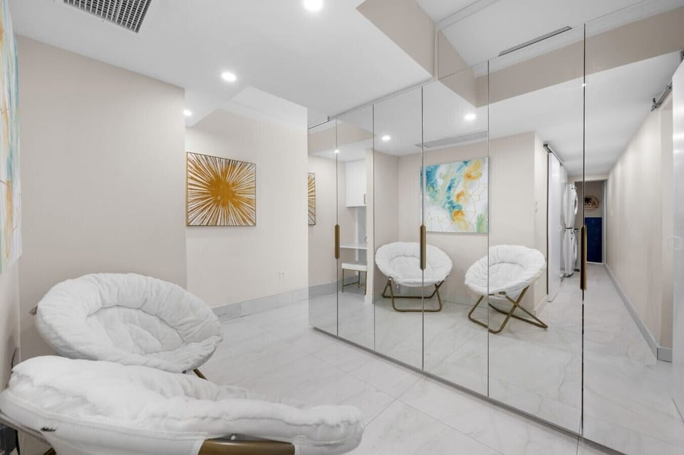 Elegant mirrored wardrobe hallway with a relaxing reading chair