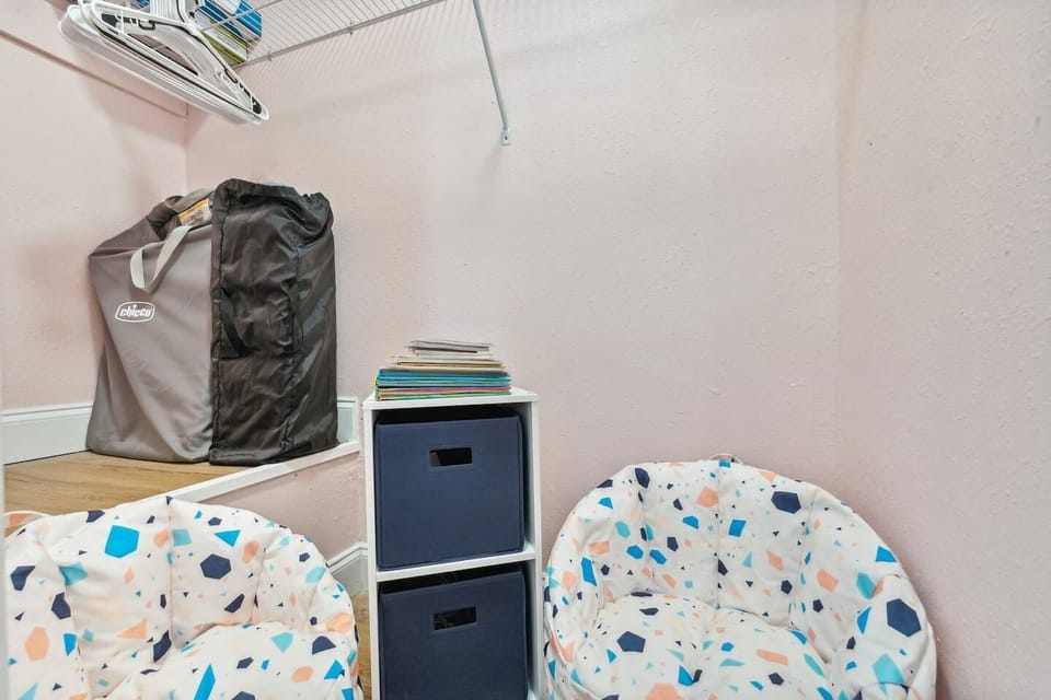 The walk-in closet that is located in the second bedroom stores pack and play, kids chairs, books and toys.