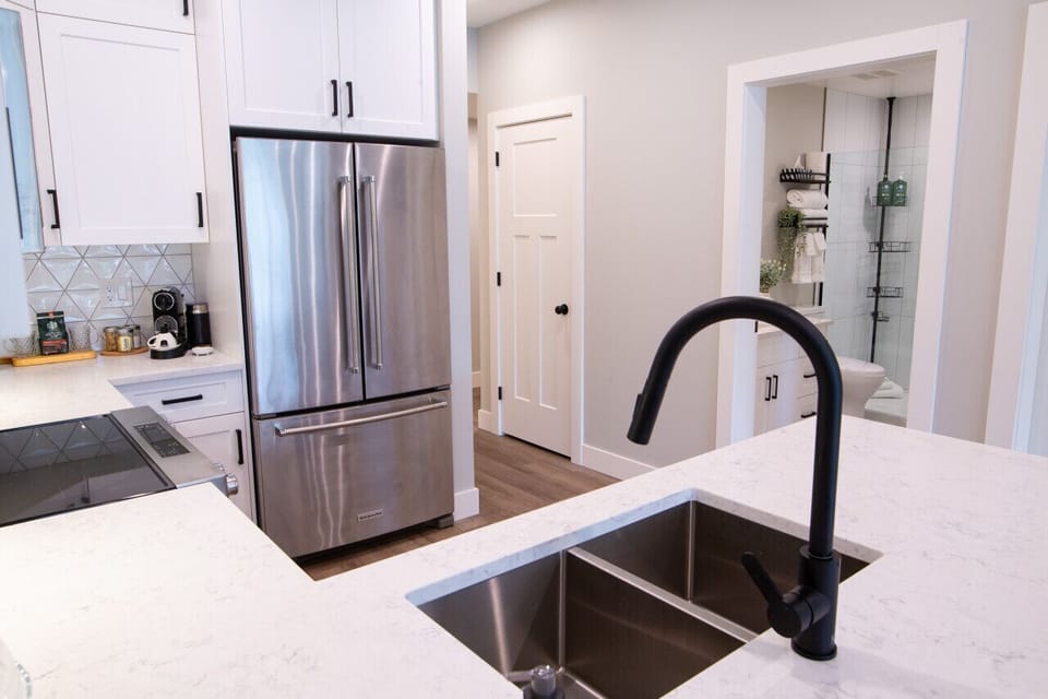 Our kitchen has a fridge, stove, dishwasher, double sink, and everything you needs to make a nice meal.