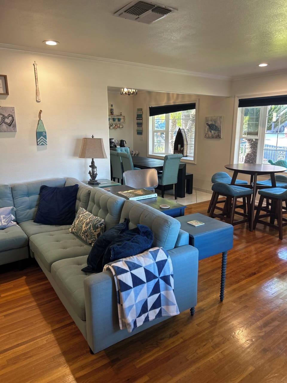 The living room is open to a fireplace seating area and adjoining dining room
