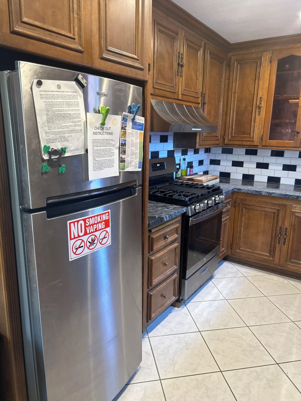 The kitchen has a fridge, dishwasher, and gas range