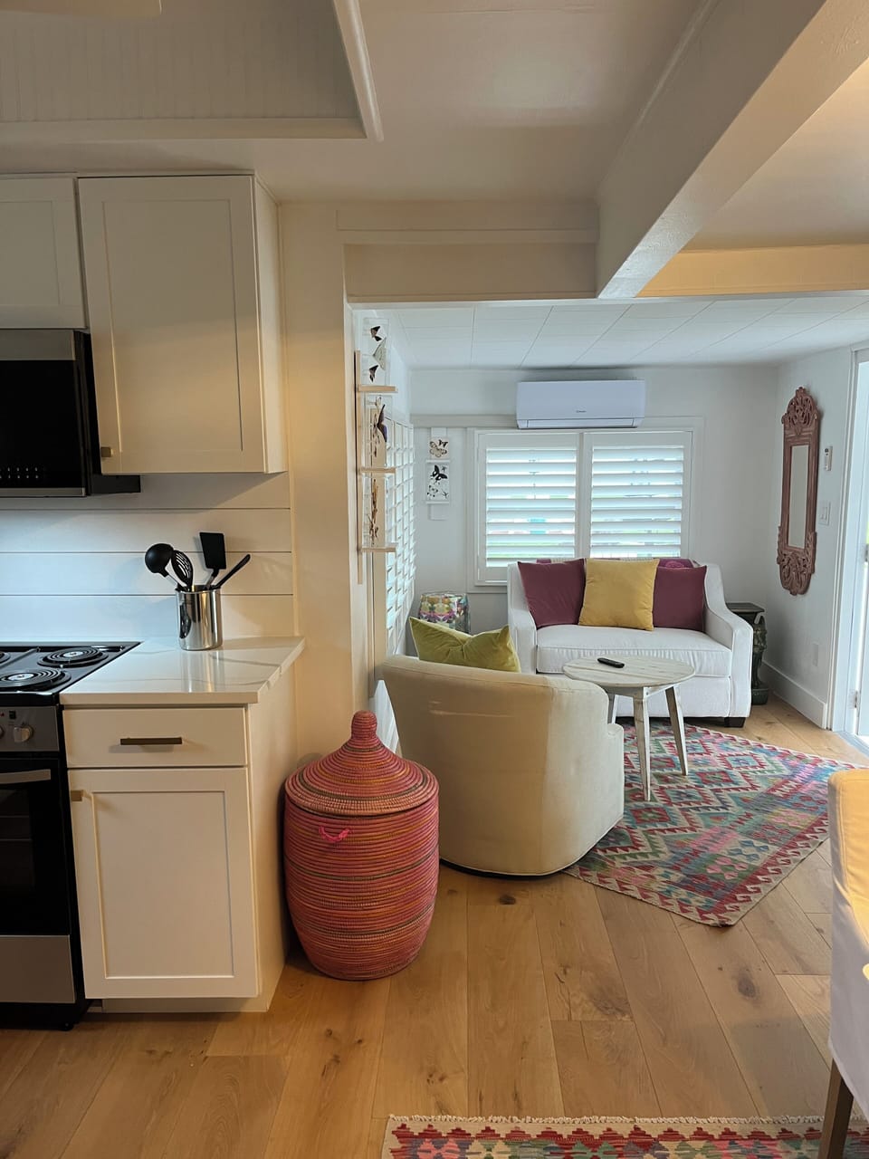 Cotrage B is on the left side with the  brick pad, Adirondack chairs &umbrella