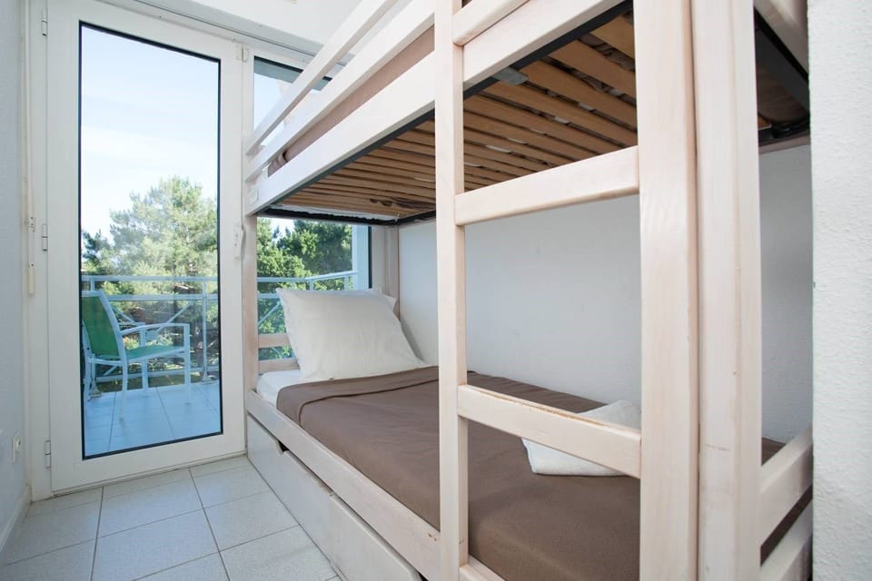 The cozy sleeping alcove features a Bunk bed.