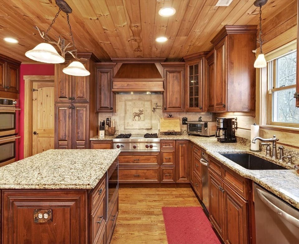 Fully equipped kitchen with island seating for 4, dining for 8, dishwasher, and two types of coffee makers (standard drip-style and Keurig)