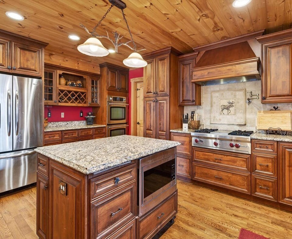 Fully equipped kitchen with island seating for 4, dining for 8, dishwasher, and two types of coffee makers (standard drip-style and Keurig)