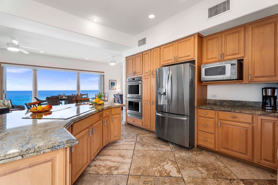 The gourmet kitchen is equipped with granite countertops, professional-grade appliances, and a spacious island for culinary adventures