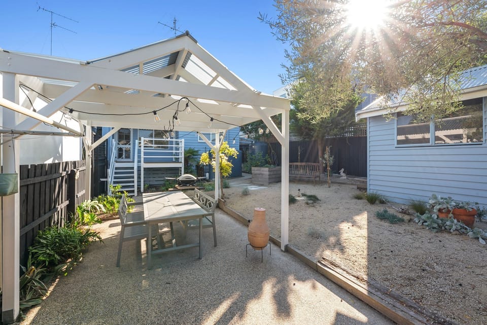 Step outside to the rear deck and courtyard, where the private garden calls for alfresco dining or a peaceful morning coffee