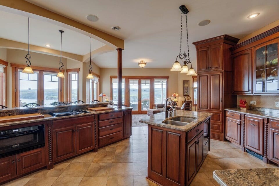 Large Kitchen with two islands and windows facing toward the lake