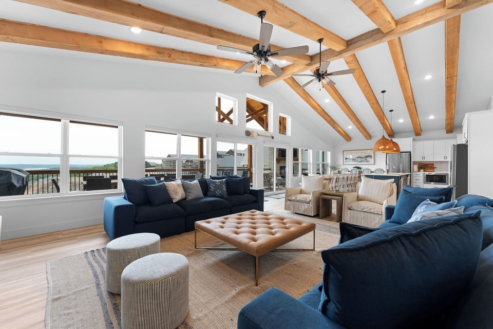 A grand open concept living space with rustic wood beams!
