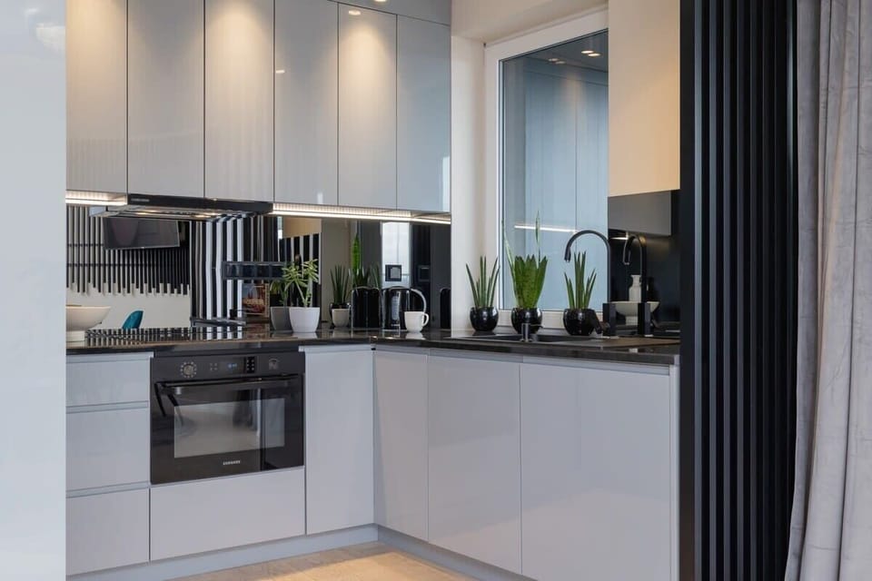 Alternative view of the kitchen highlighting glossy surfaces and ample counter space.

