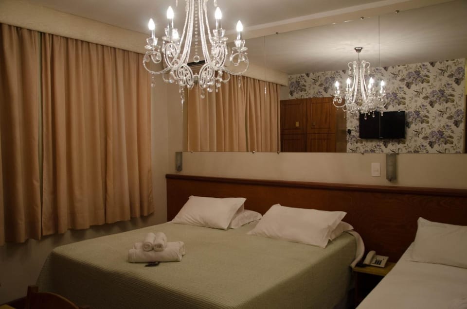Executive Triple Room | Minibar, in-room safe, desk, blackout drapes