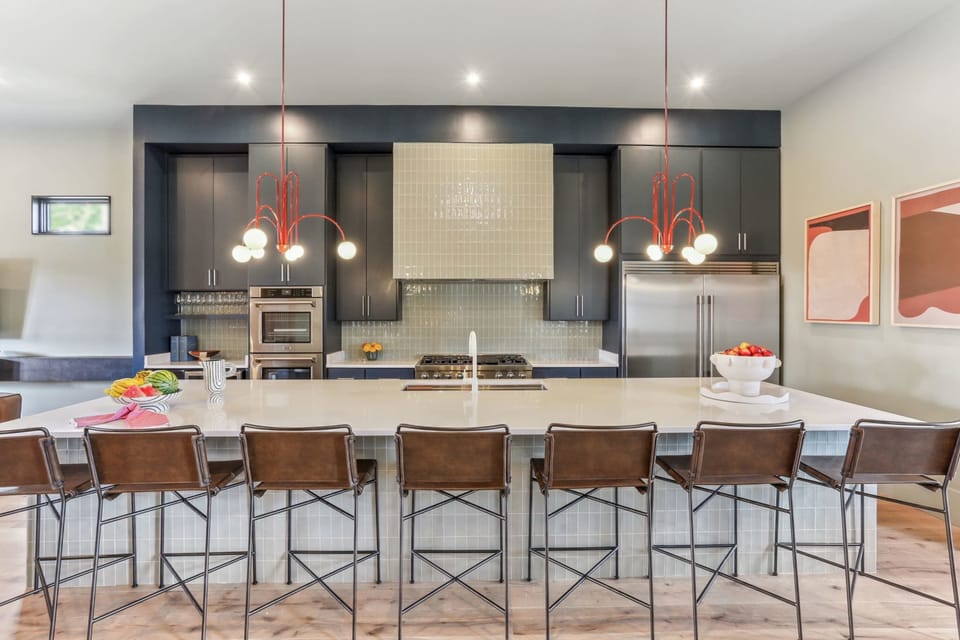 Kitchen | Chef's Kitchen with Large Island and Bar Seating Full View | First Floor