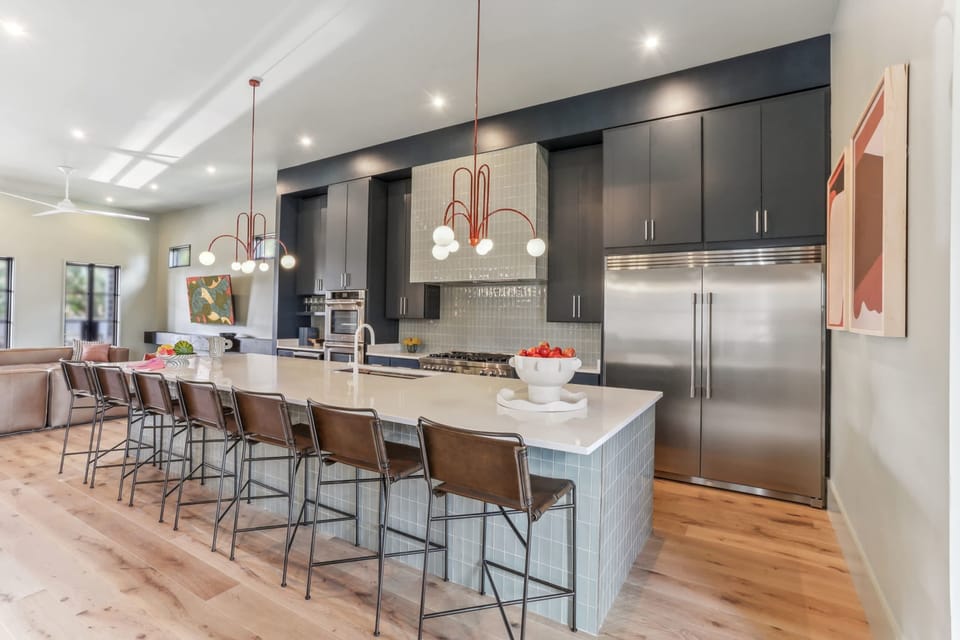 Kitchen | Chef's Kitchen with Large Island and Bar Seating Full View | First Floor
