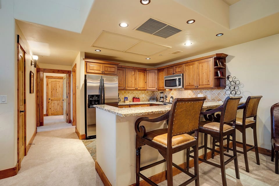 You'll love cooking in this elegant kitchen with granite counters, stainless appliances, and warm wood cabinetry—perfect for memorable meals.
