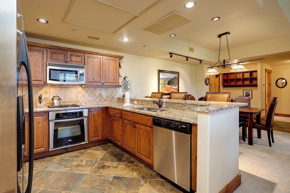 Your gourmet kitchen features granite countertops, rich wood cabinetry, and premium appliances for memorable meal preparation.