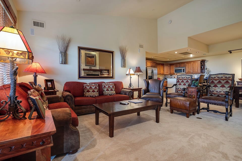 Sink into plush southwestern-style seating with warm lamps creating perfect ambiance for your evening relaxation in this thoughtfully designed living space.