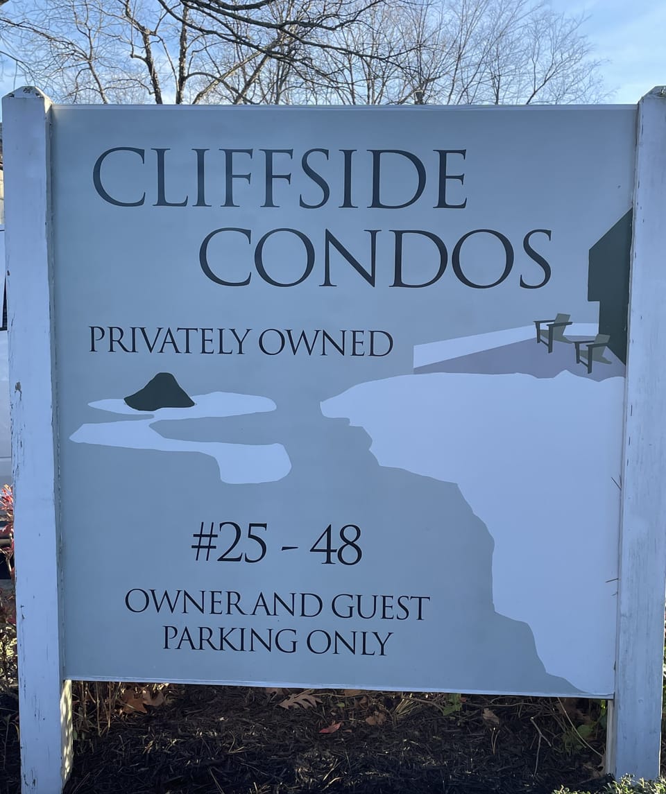 Sign to entrance of condos.