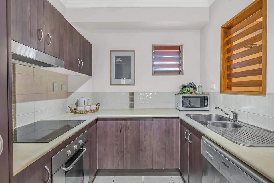 A classic kitchen comes fully equipped for preparing meals at home including a dishwasher for easy cleanup. 
