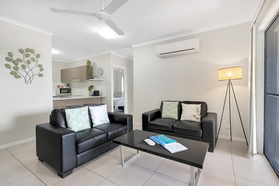 Cosy up in the living area, equipped with cooling, ceiling fans and two leather lounges.