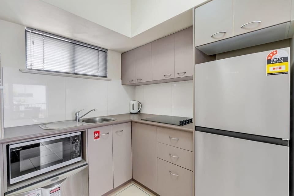 The fully equipped kitchen invites you to cook meals at home with a cooktop, dishwasher, microwave, and full-size fridge and freezer. 