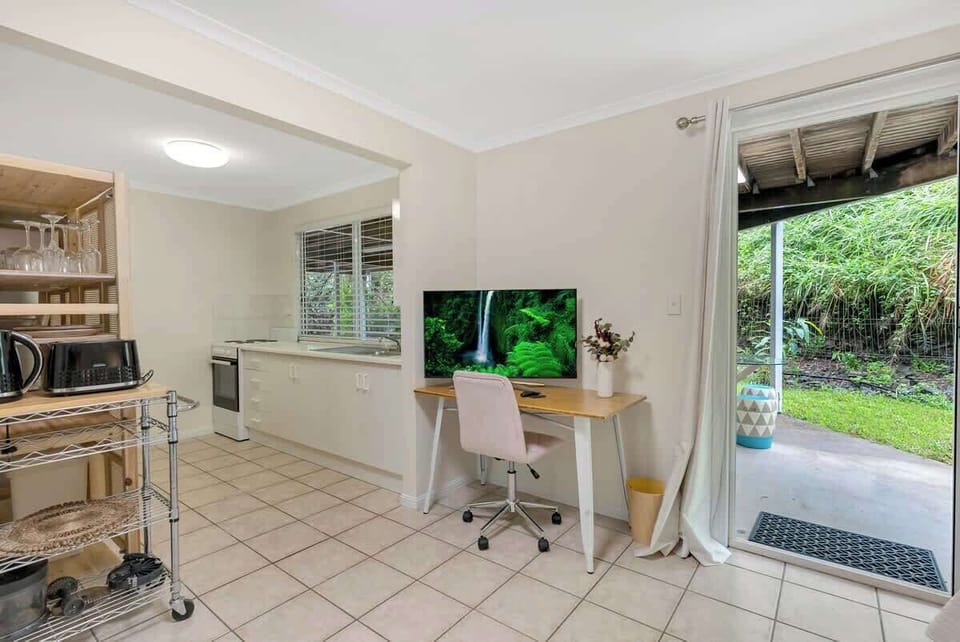 The studio is equipped with a dedicated workspace for remote work or catching up on emails. 