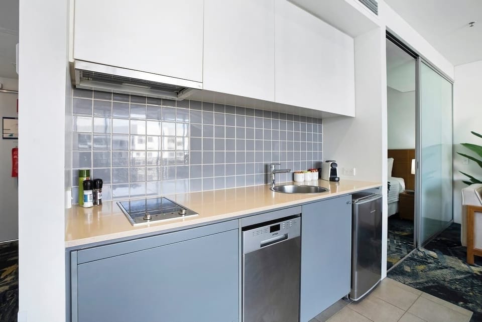 Prepare delightful meals in the fully equipped kitchen, complete with a dishwasher, ceramic hot plates, and a small fridge. 