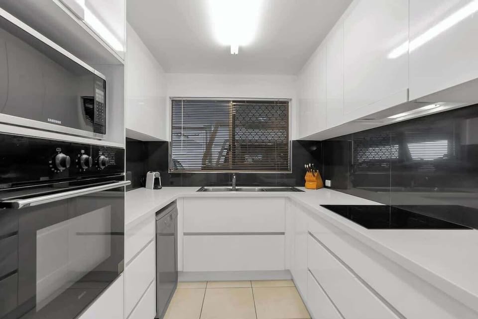 Whip up delicious meals in the fully-equipped kitchen, complete with modern appliances and ample benchtop space. 