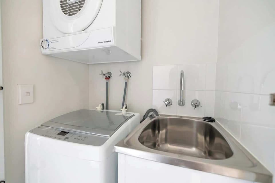 The in-unit laundry is equipped with washing and drying facilities, adding to your convenience during your stay.
