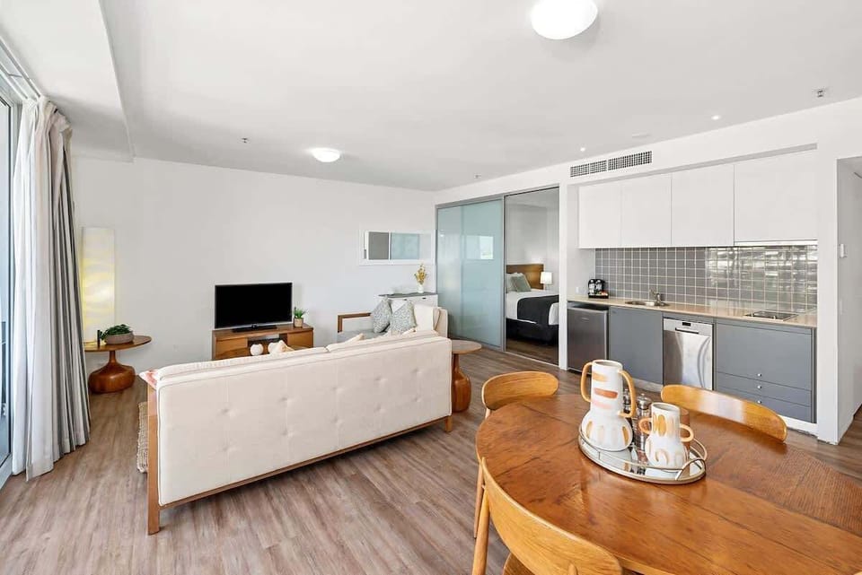 Enjoy meals at the cosy dining table for four, perfectly situated to take advantage of the apartment's open-concept layout and beautiful natural light.