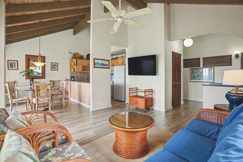 Step into your airy, island-style retreat where vaulted wood-beam ceilings and an open layout invite natural light and tropical breezes. Relax on plush seating, gather around the dining table, and enjoy modern comforts—your perfect Hawaiian escape.