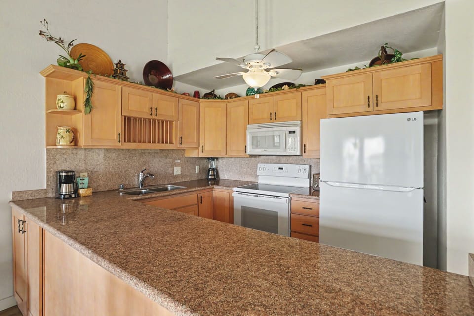 Your fully equipped kitchen features granite countertops, modern appliances, and ample cabinet space—perfect for preparing home-cooked meals during your stay.