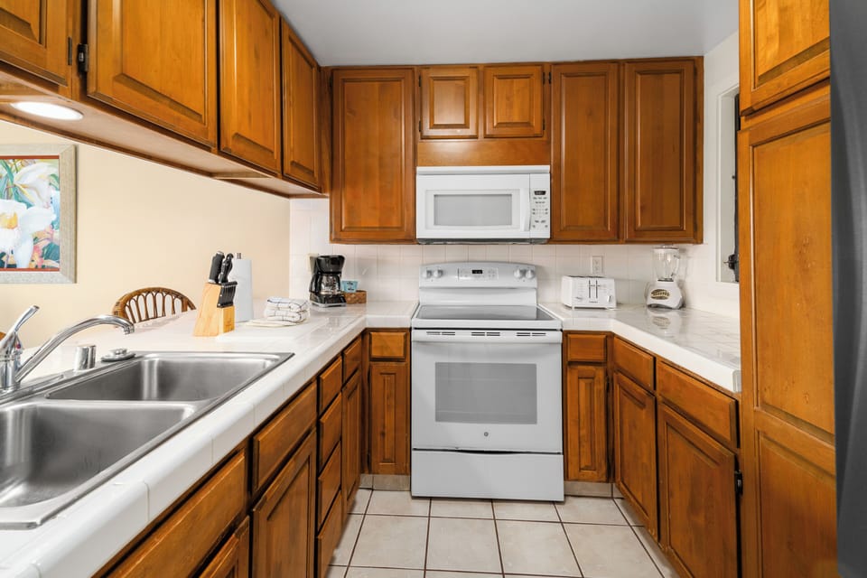 Your fully equipped kitchen features warm wood cabinetry, modern appliances, and everything needed to prepare meals during your stay.