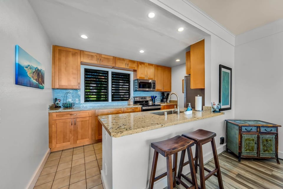 With sleek cabinetry, a spacious island, and a cozy atmosphere