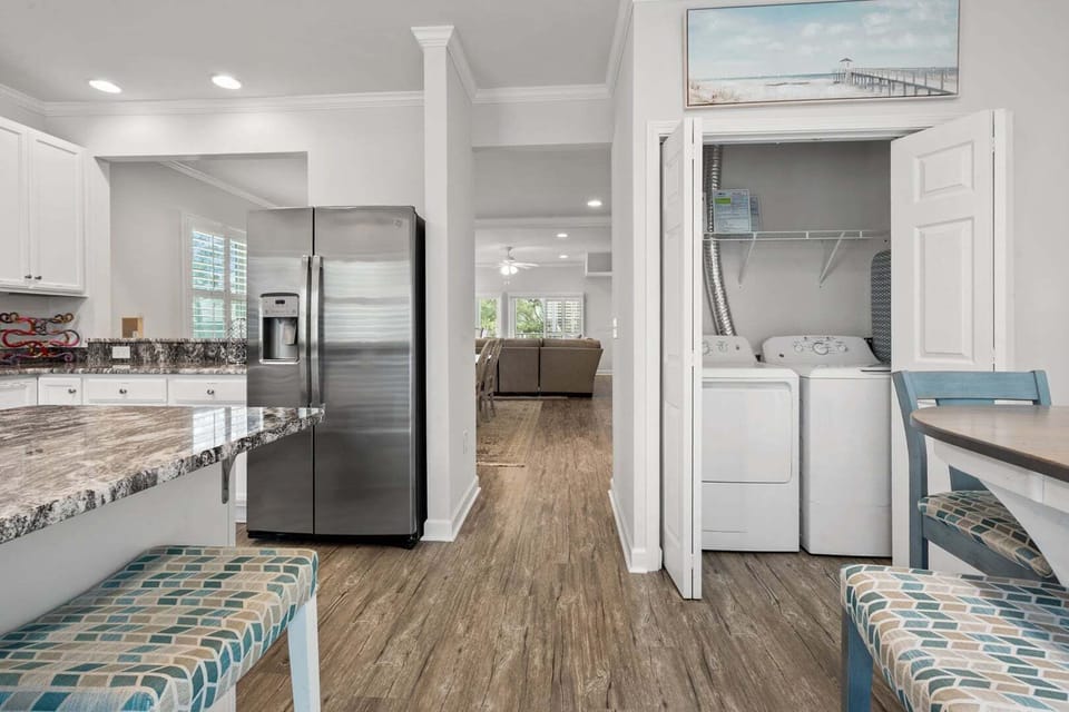 Washer and dryer tucked beside the kitchen at Ocean Keyes 1301, a 4-bedroom Ocean Drive vacation rental