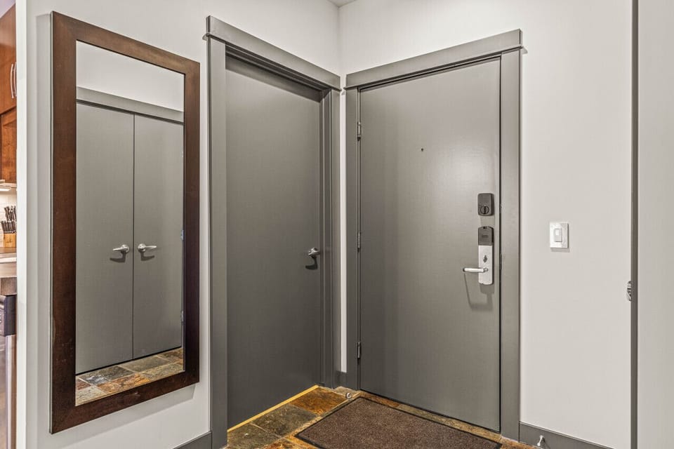 Entry space with large coat closet, laundry room and full sized mirror for getting ready